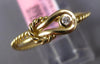 ESTATE SMALL .03CT DIAMOND 14KT YELLOW GOLD CLASSIC SOLITAIRE LOVE KNOT FUN RING